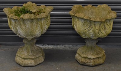 Lot 153 - A pair of composite stone urns on stands,...