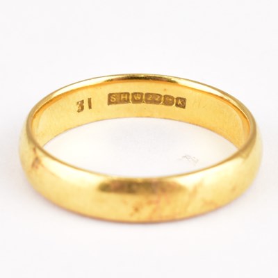 Lot 717 - A 22ct gold wedding band, size N, approx. 4.5g.