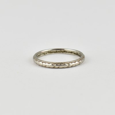 Lot 712 - A platinum thin band ring with repeating...