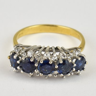 Lot 785 - A yellow gold ring set with five claw set...