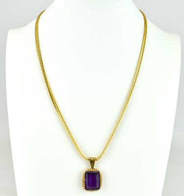 Lot 854 - A square cut amethyst in 9ct gold pendant...