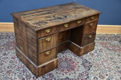 Lot 298 - A 19th century oak knee-hole desk, with...