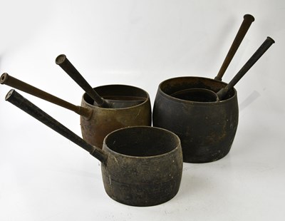 Lot 1203 - A collection of five cast iron saucepans,...