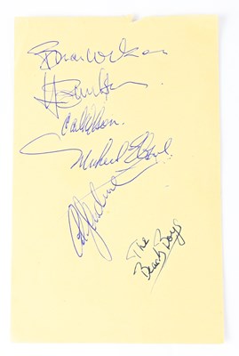 Lot 555 - THE BEACH BOYS; a torn page from an autograph...