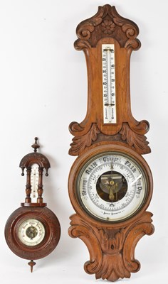 Lot 169 - A 20th century carved oak barometer, height...