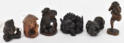 Lot 604 - A group of six carved hardwood netsukes...