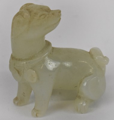 Lot 645 - A small Chinese white jade figure of a dog,...