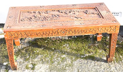 Lot 34 - A modern Chinese carved coffee table decorated...