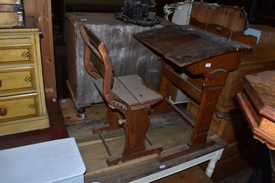 Lot 1300 - A vintage pine child's desk with adjustable...