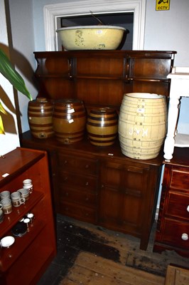 Lot 1433 - ERCOL; a medium elm dresser, the boarded back...