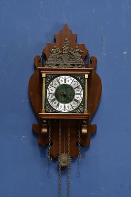 Lot 2056 - A modern wall clock with fine brass decoration...