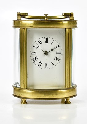 Lot 2069 - A French brass cased oval carriage clock with...