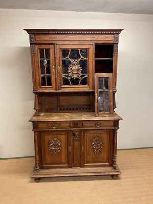 Lot 663 - A French oak buffet comprising three sections...