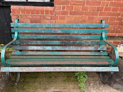 Lot 603 - A green painted iron garden bench, width 155cm.