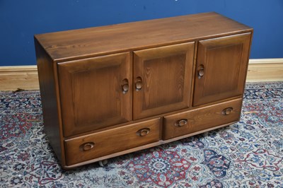 Lot 315 - ERCOL; a medium elm 'Golden Dawn' sideboard,...