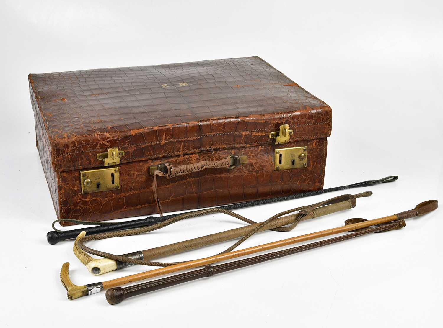 Lot 1028 - A crocodile skin travelling case, enclosing...