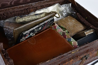 Lot 1028 - A crocodile skin travelling case, enclosing...