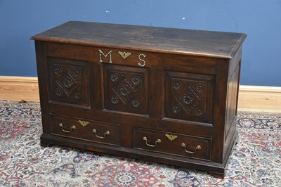 Lot 275 - An 18th century carved oak coffer, with carved...