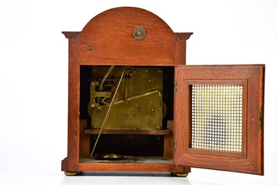 Lot 2131 - A 1920s oak cased mantel clock, with arched...