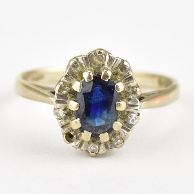 Lot 741 - An 18ct gold diamond and sapphire cluster ring,...