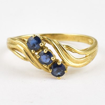 Lot 762 - A 9ct gold ring with claw set sapphire to...