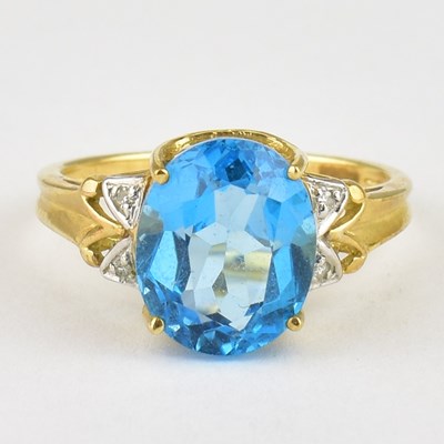 Lot 754 - A 9ct gold dress ring with large claw set blue...