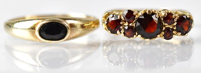 Lot 789 - Two 9ct gold rings, one set with red stones,...