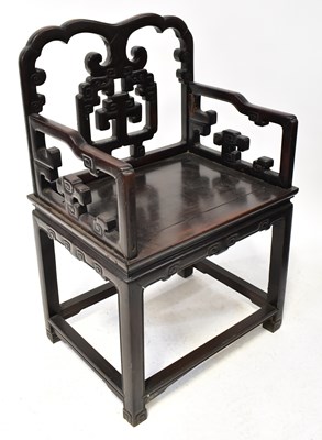 Lot 434 - A Chinese hardwood panelled seat open elbow...