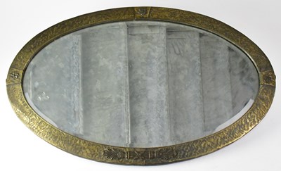 Lot 85 - An Arts and Crafts oval hammered brass...