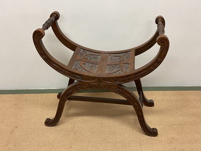 Lot 700 - A carved oak stool, height 67cm, width 69cm,...