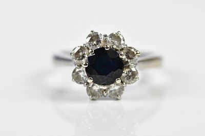 Lot 129 - An 18ct white gold sapphire and diamond...