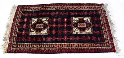 Lot 137 - An Afghan and Turkmen Beluch hand-knotted rug,...