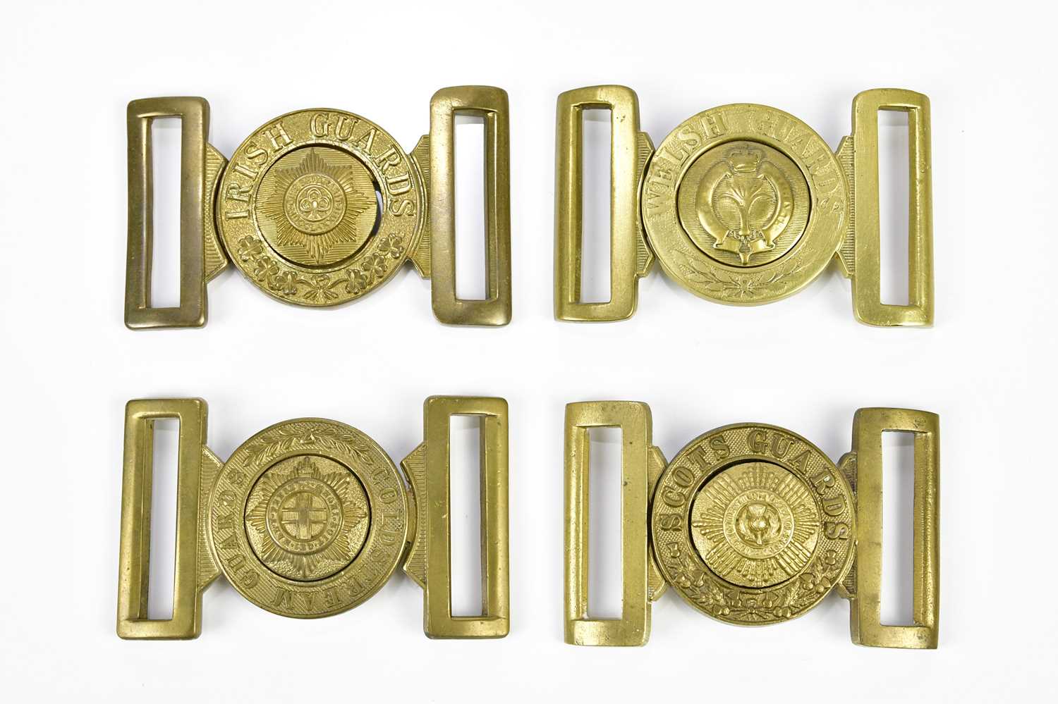 Lot 1609 - A group of four brass army belt buckles...