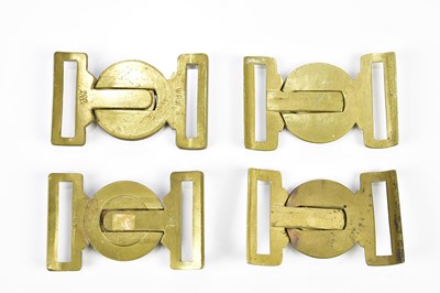 Lot 1609 - A group of four brass army belt buckles...