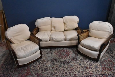 Lot 48 - A three piece Bergere suite with cream...