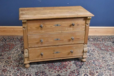 Lot 285 - A Continental pine chest of three drawers on...