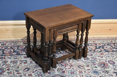 Lot 250 - A reproduction oak nest of three graduated...