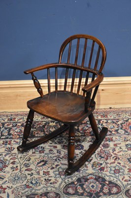 Lot 288 - A 19th century elm child's Windsor elbow chair.