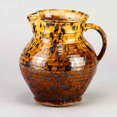 Lot 476 - Winchcombe Pottery; a slipware jug partially...