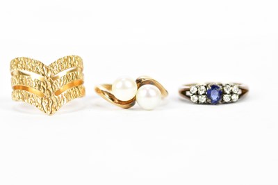 Lot 214 - Three yellow metal dress rings, one set with...