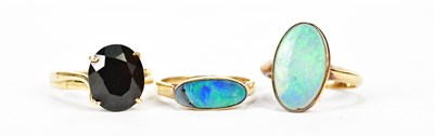 Lot 215 - Two opal set yellow metal dress rings, both...