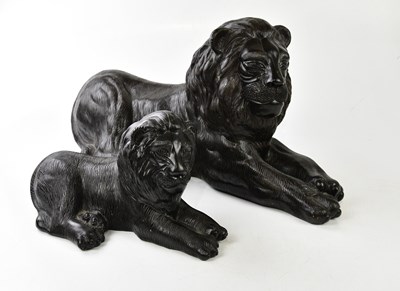 Lot 388 - Two black modern models of lions, length of...