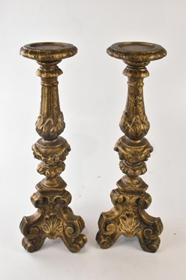 Lot 2238 - A pair of decorative gilt candle holders in a...