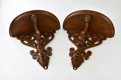 Lot 1021 - A pair of Victorian oak brackets, height 37cm.