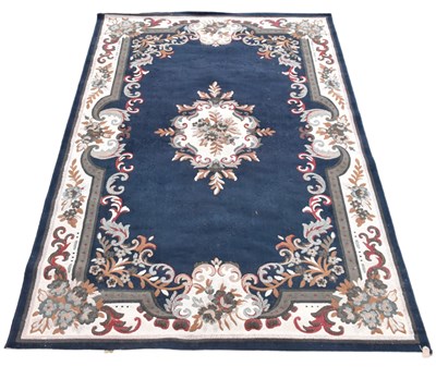 Lot 337 - A machine woven carpet, worked with a central...