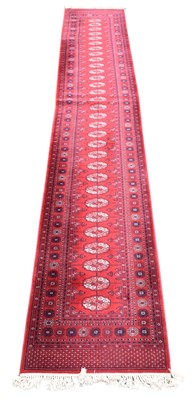 Lot 343 - A Bokhara machine woven runner worked with...