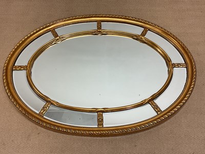 Lot 655 - A contemporary decorative gilt oval wall...