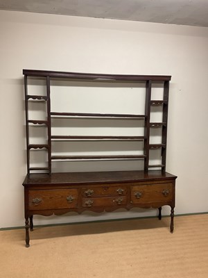 Lot 636 - An early 19th oak dresser with open plate rack,...