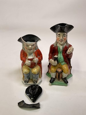 Lot 202 - An early 19th century Staffordshire toby jug...