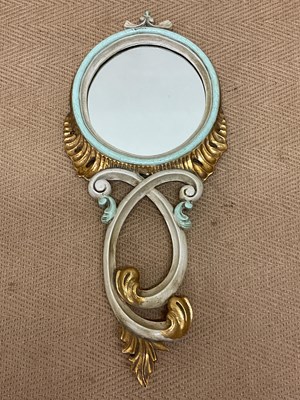 Lot 666 - A decorative circular wall mirror with two...